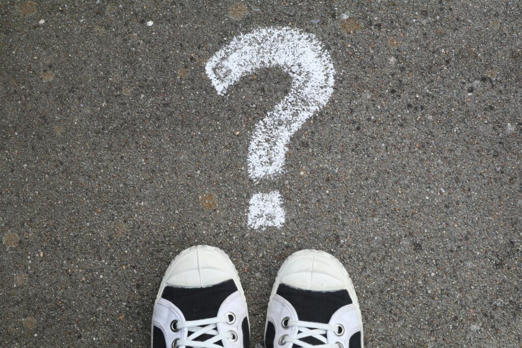 What Can I Run on a 1000W Solar Generator During a Blackout? Sneakers on pavement with a chalk question mark, symbolizing curiosity or decisions.