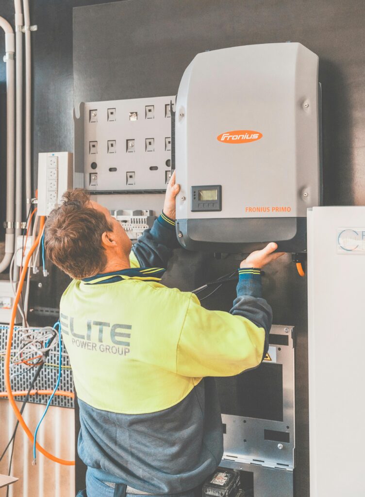 Expert technician setting up a solar inverter in Thornton, NSW, ensuring efficient solar energy flow.