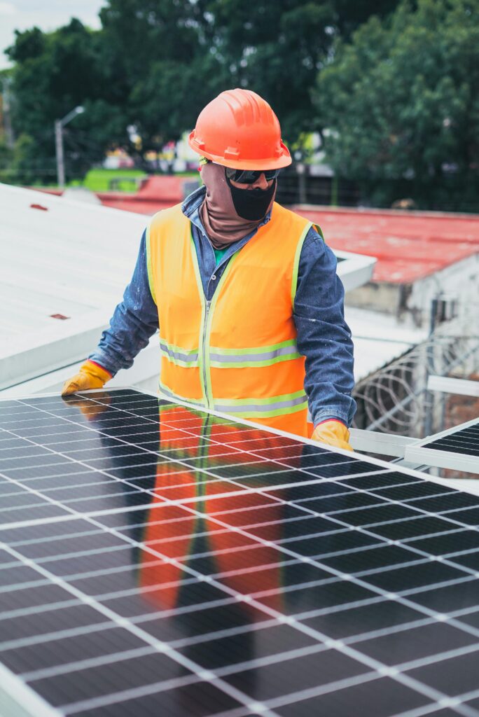 Solar Generator Troubleshooting Guide: Fix Every Problem Before the Sun Goes Down Technician in protective gear installing solar panels on a sunny day.